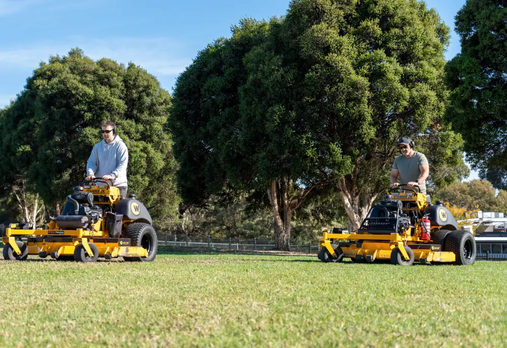 Efficient acreage mowing with ride-on equipment by fully insured lawn specialists
